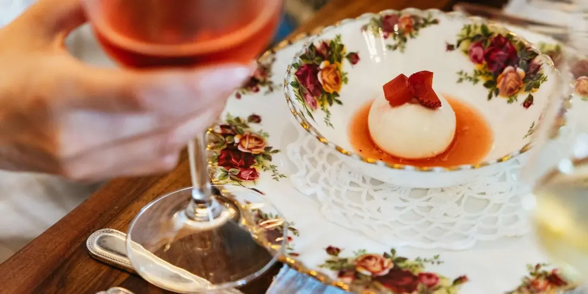 A plate of food served beside a glass of wine